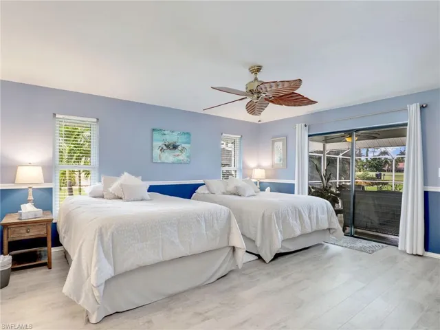 Master Bedroom featuring access to outside, land ceiling fan
