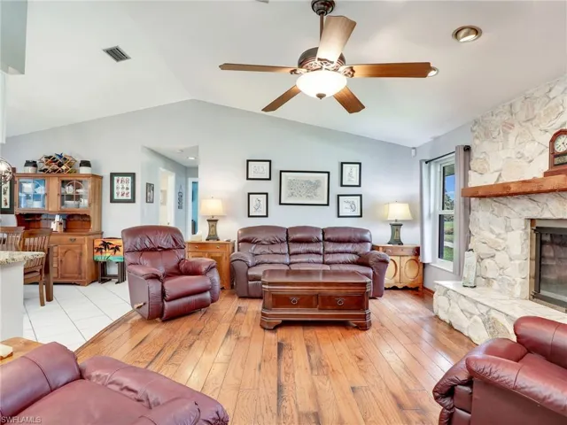 Family room with vaulted ceiling and ceiling fan