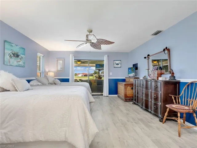Master Bedroom featuring access to outside, ceiling fan, and light