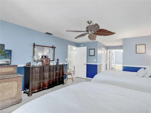 Master Bedroom featuring ceiling fan and ensuite bath