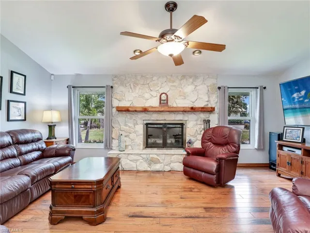 Family room with a fireplace and ceiling fan