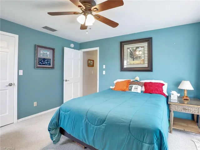 Carpeted bedroom with ceiling fan
