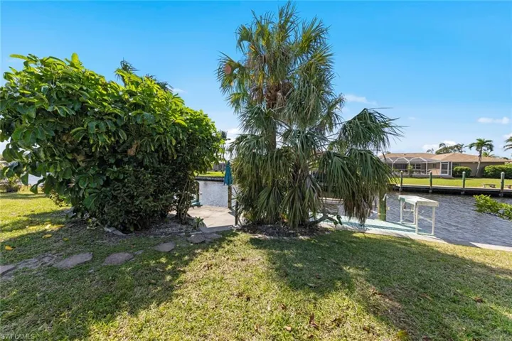 View of yard featuring a water view and a boat dock