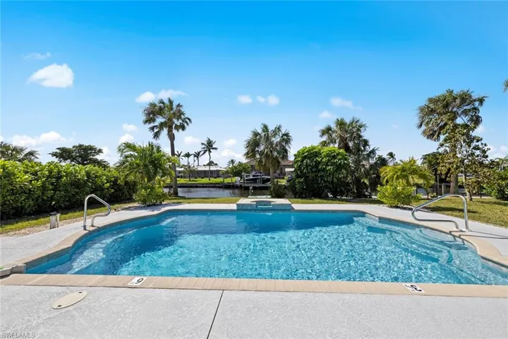 View of swimming pool with a water view and a pool