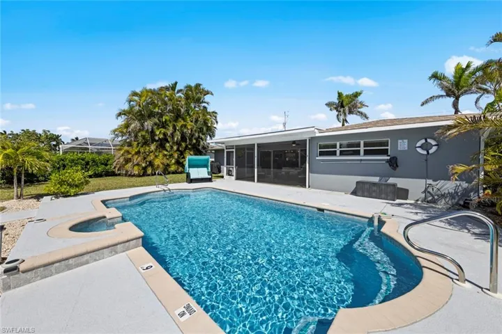 Pool with a sunroom and a patio area