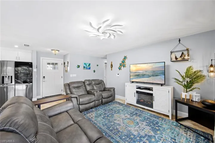 Living room with baseboards and a fireplace