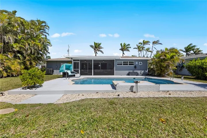 Pool with a sunroom, a yard, and a patio