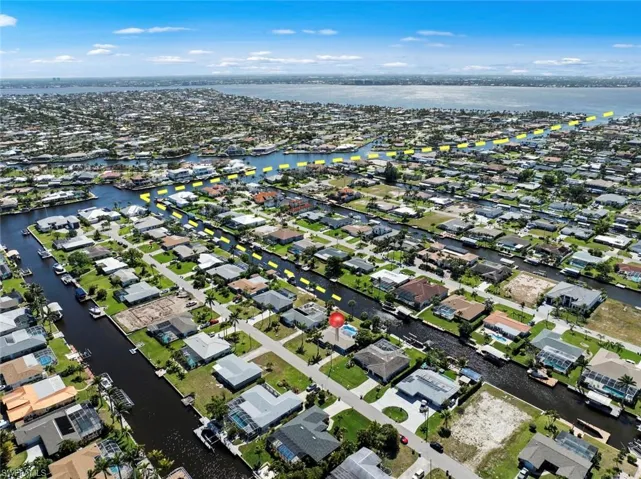 Birds eye view of property with a water view and a residential view