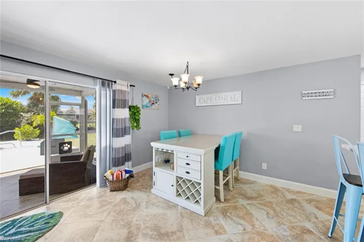 Dining area featuring baseboards and an inviting chandelier