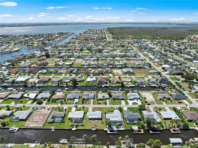 Birds eye view of property with a water view and a residential view