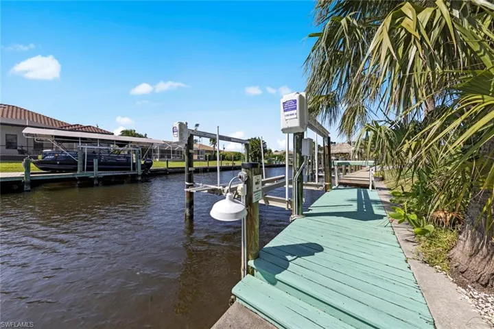 View of dock with a water view and boat lift
