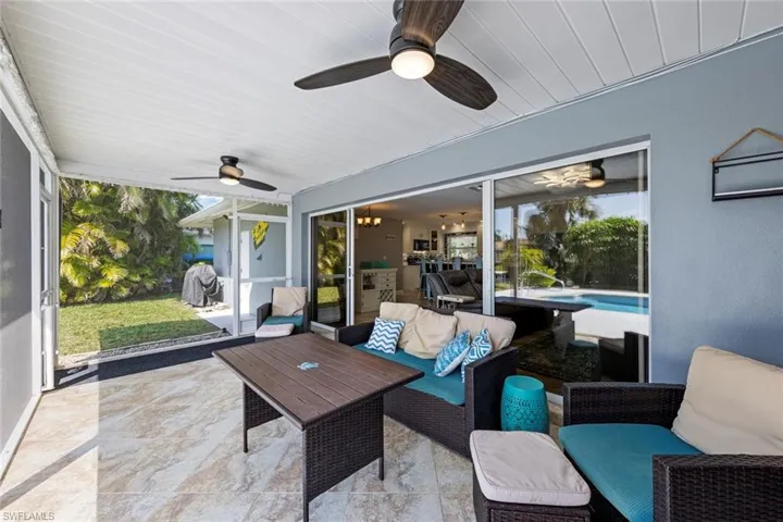 Screened/covered patio with outdoor lounge area and a ceiling fan