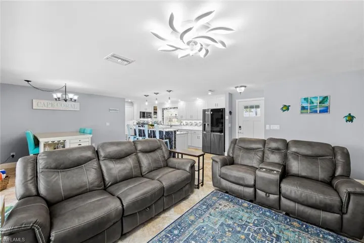 Living area ceiling fan with notable chandelier