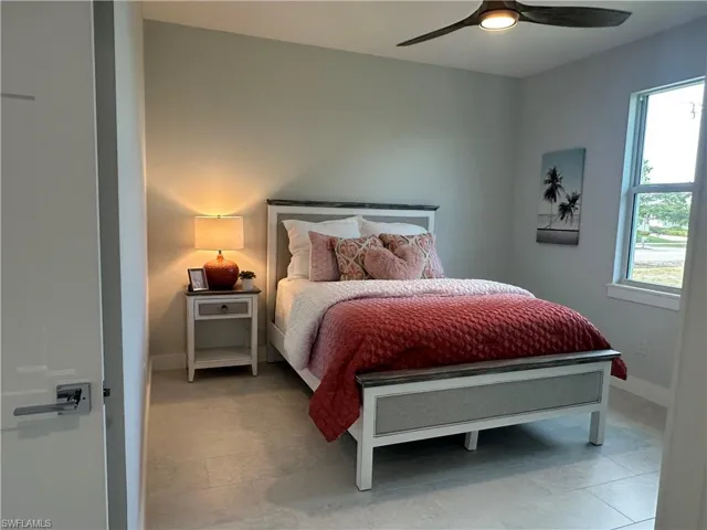 Bedroom with ceiling fan and multiple windows