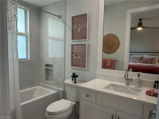 Full bathroom featuring ceiling fan, shower / bath combination, vanity, and toilet