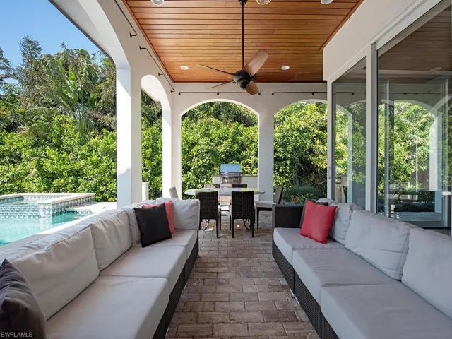 View of patio / terrace with outdoor dining area, outdoor lounge area, a ceiling fan, an outdoor kitchen, and a pool with connected hot tub