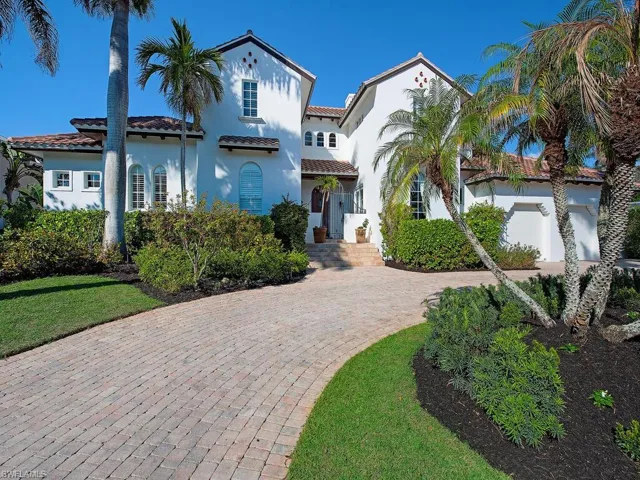 Mediterranean / spanish home with a tiled roof, decorative driveway, and stucco siding