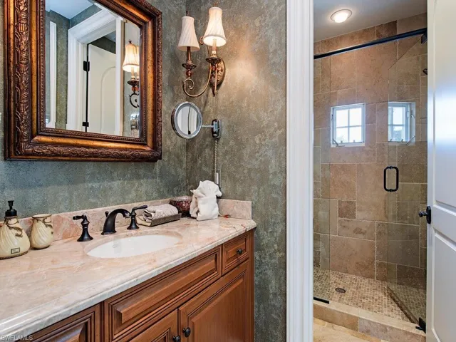 Bathroom with a shower stall and vanity