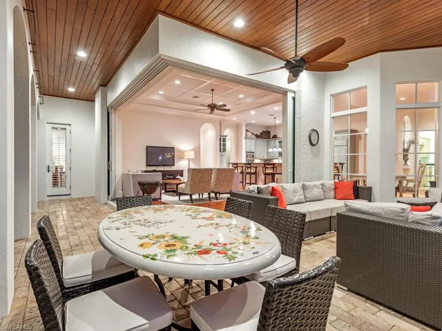 Dining room featuring arched walkways, wood ceiling, recessed lighting, ceiling fan, and stone tile floors