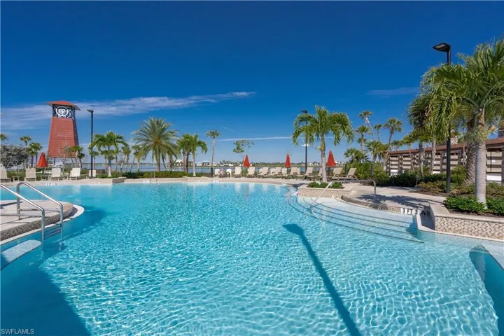 Large resort style pool with clubhouse and BBQ grill cabanas