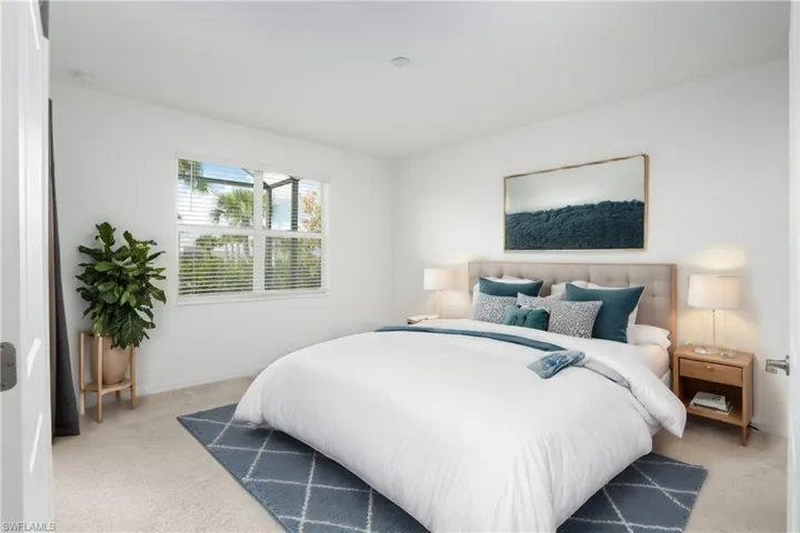 Beautiful Primary Suite with window over looking the back yard as well as dual sliders to your patio area that is screened in.
