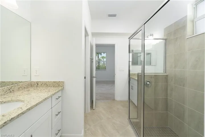 Primary bath with separate vanities, glass shower and water closet