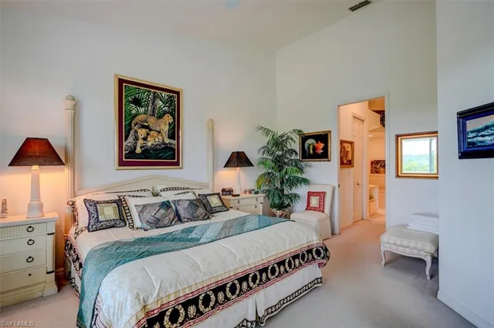 Bedroom with light carpet, ensuite bathroom