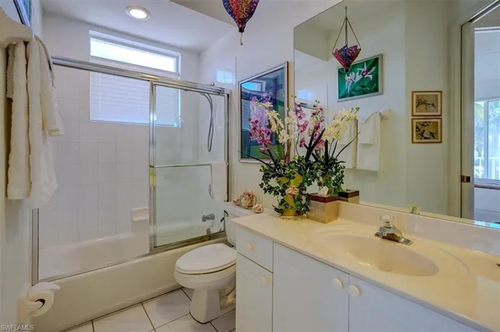 Full bath with tile patterned floors, toilet, recessed lighting, combined bath / shower with glass door, and vanity