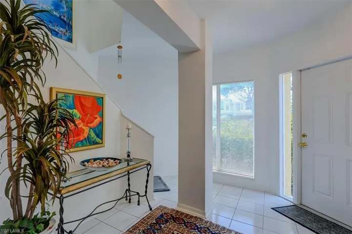 View of tiled entrance foyer with stairwell to 2nd floor