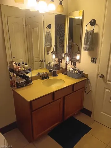 Bathroom featuring tile patterned flooring and vanity