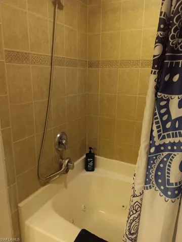 Bathroom with shower / bath combo with shower curtain