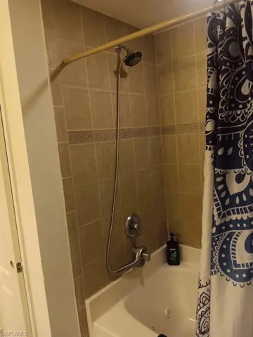 Bathroom featuring shower / bath combo with shower curtain