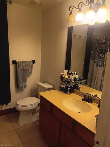 Bathroom with tile patterned flooring, vanity, and toilet