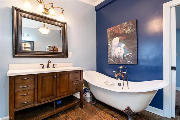 Lower level primary bathroom with clawfoot soaking tub