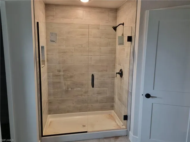 Full bathroom with a shower stall
