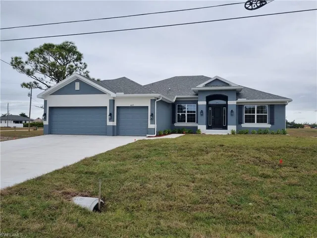 Single story home with stucco siding, a front lawn, driveway, an attached garage, and a shingled roof