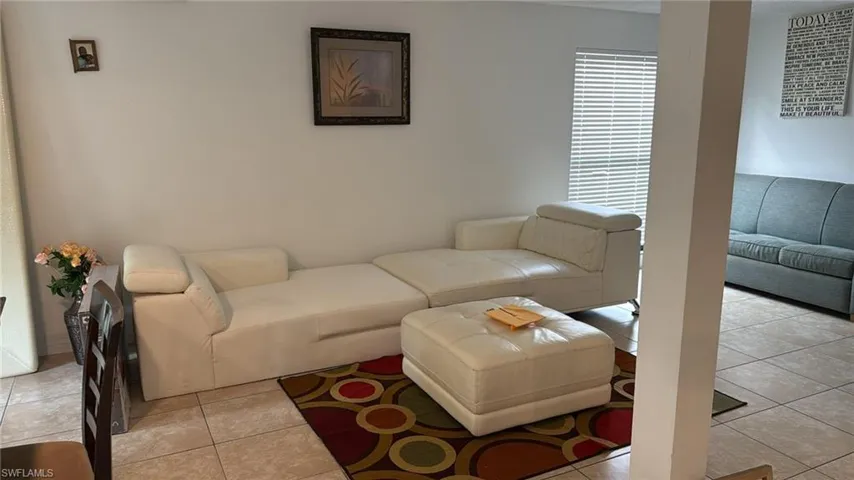 Living area featuring light tile patterned floors