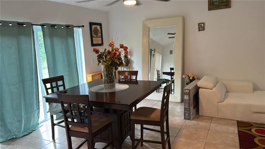 Dining space featuring light tile patterned floors and ceiling fan