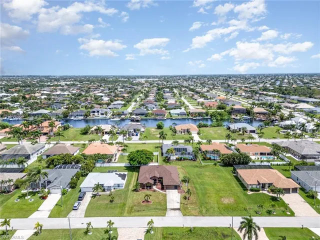 Aerial view of residential area featuring a nearby body of water