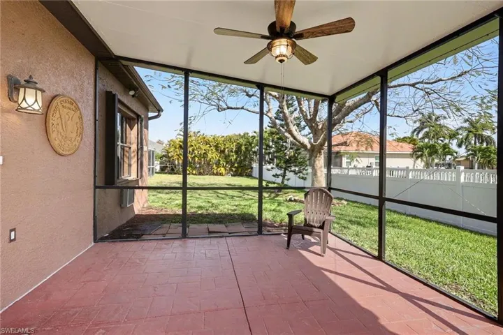 Unfurnished sunroom featuring ceiling fan