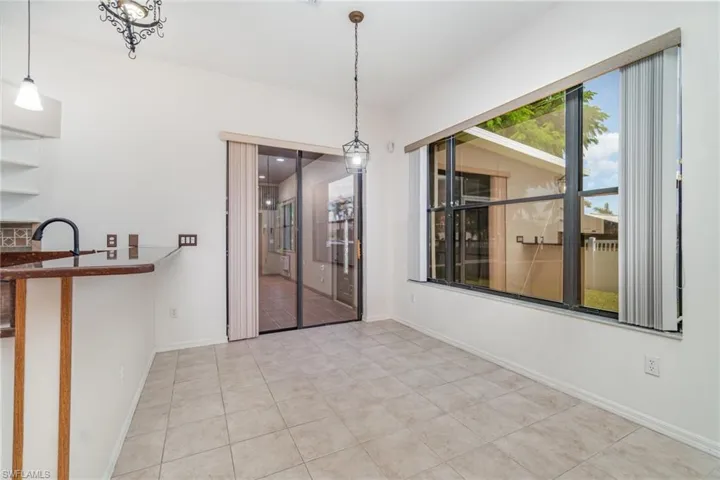 Unfurnished dining area with baseboards and light tile patterned floors
