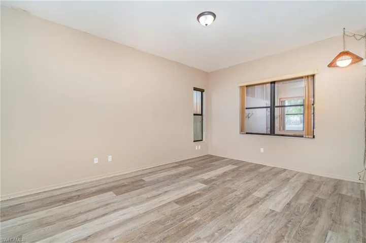 Spare room featuring light wood finished floors and baseboards