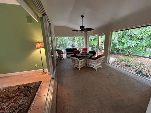 Sunroom / solarium featuring lofted ceiling and baseboards