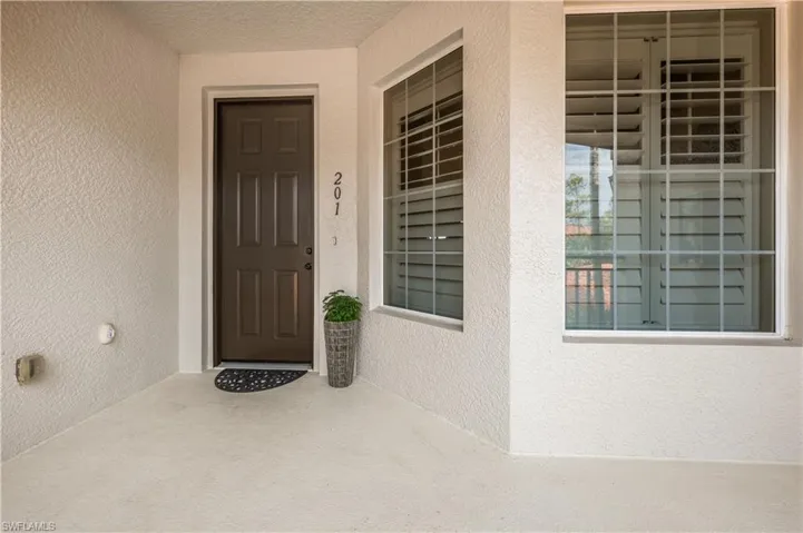 Entrance to property with stucco siding