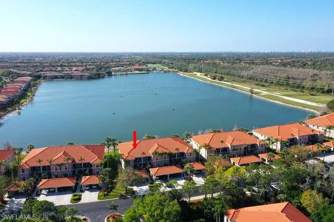 Birds eye view of property with a water view and a residential view