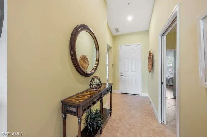 Corridor featuring visible vents and baseboards
