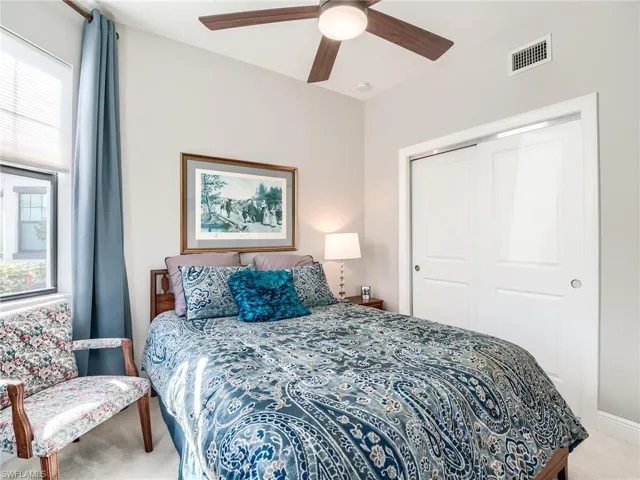 Bedroom featuring carpet flooring, a closet, and ceiling fan
