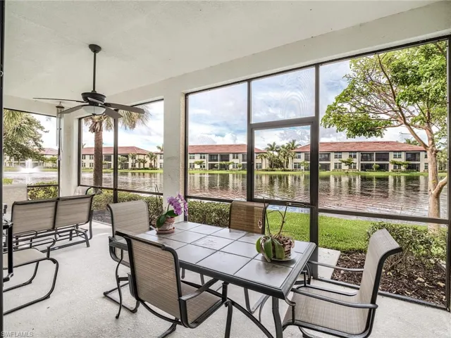 Sunroom / solarium featuring a water view and ceiling fan