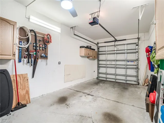 Garage featuring ceiling fan and a garage door opener