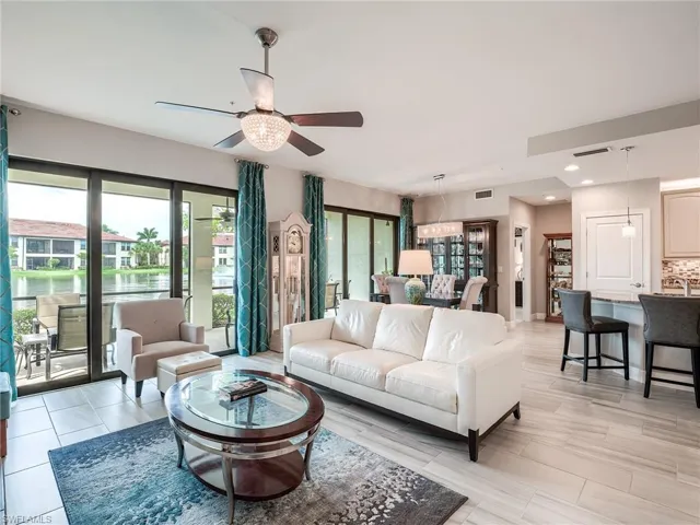 Tiled living room featuring ceiling fan